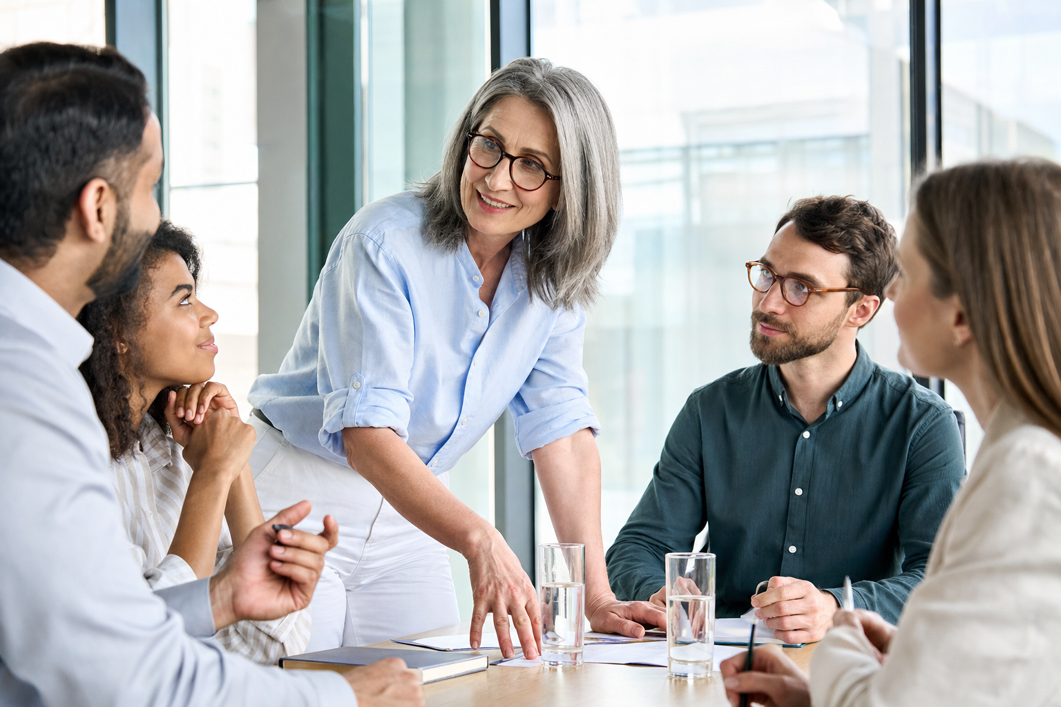 HR leader guiding a team discussion in a bright office